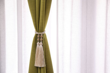 Beautiful curtains with tieback indoors, closeup