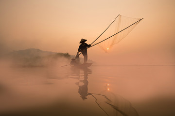 Two fishermen are fishing on the boat at Mekong river in the morning in Nong Khai, Thailand - obrazy, fototapety, plakaty