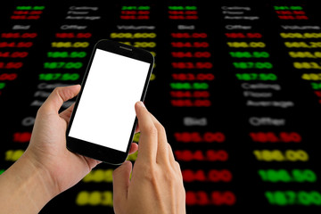 hand hold and touch screen smart phone,tablet,cellphone on stock chart market background.