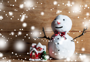 Obraz premium Small snowman on wood desk