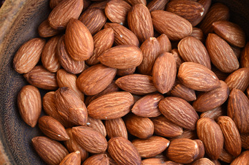 close up of almonds on wooden background