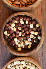 hazelnut and almond with pistachios in wooden bowl 