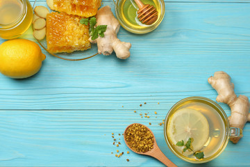 healthy background. honey, honeycomb, lemon, tea, ginger on blue wooden table. Top view with copy space