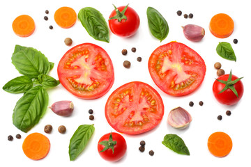 mix of slice of tomato, basil leaf, garlic and spices isolated on white background. top view