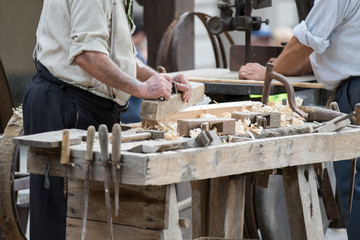 Asti, Italy - September 10, 2017: carpenter works wood with its tools