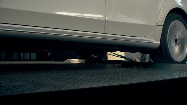 Automobile on stand for measuring car power. Modern equipment in car servicing
