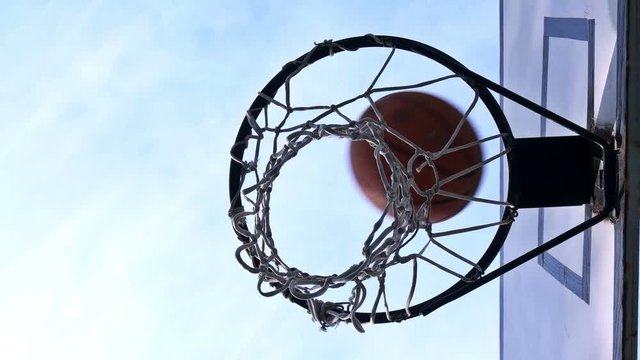 the basketball enters the basket outdoors