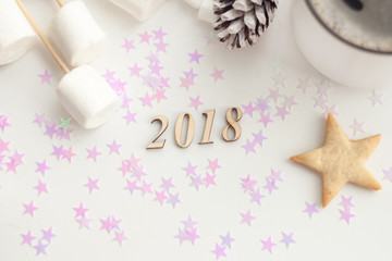 Fototapeta na wymiar Coffee and cookies with Christmas and New Year decoration, number of year 2018
