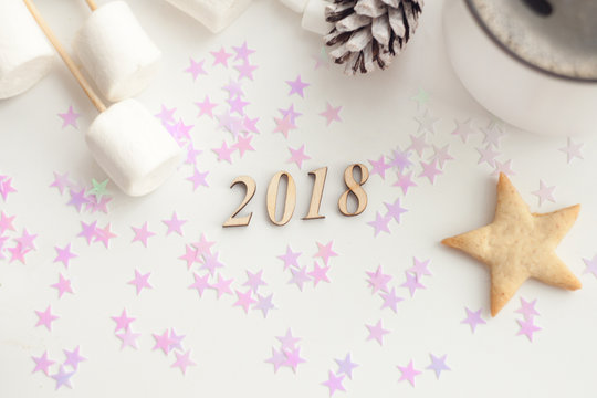 Coffee and cookies with Christmas and New Year decoration, number of year 2018