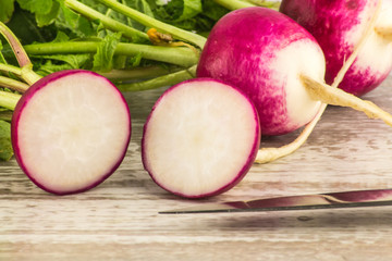 pink and white radish close and cut on the board