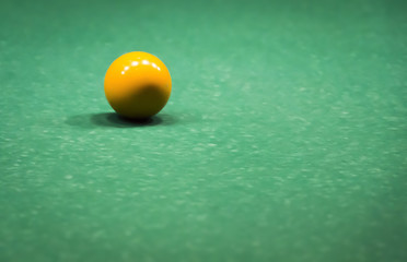 Colored ball on a green billiard table close-up.