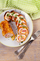 Сhicken breasts with cheese and bacon. Crispy, creamy chicken wraps. View from above, top studio shot, vertical