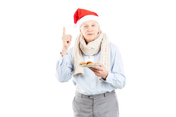 Fototapeta na wymiar Portrait of senior man in Santa hat on white background