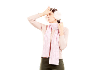Portrait of young woman wearing winter earmuffs and scarf