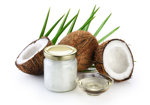 Coconut and glass jar with fresh coconut oil isolated on white background.