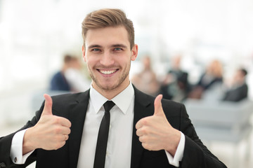 successful businessman showing thumbs up.