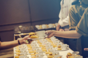 Blurred for background.Coffee break at conference meeting for seminar.Doughnut,Hamburger and white cup of coffee.