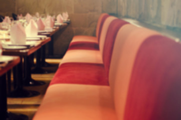 Blurred for Background.Dining table with table cloth and red chair in the restaurant.