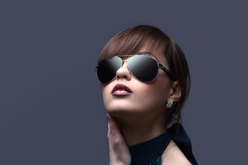 face of young woman in dark glasses.