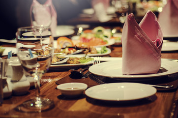 Blurred for background.food set and napkin on the dining table in the restaurant.