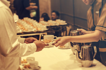 Blurred for Background.The waitress filed a glass of white coffee with the sausage between the brake and the brake food background.