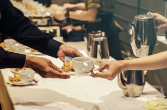 Blurred for Background.The waitress filed a glass of white coffee with the sausage between the brake and the brake food background.