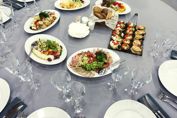 Preparation for a banquet. Wine glasses are on the tables in the restaurant.