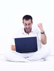 happy man working on laptop, sitting on the couch.