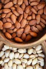 almonds and pistachios in wooden bowl for background