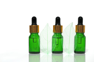 vegetable cosmetic serum for face skin. Serum in green glass bottles with pipette and skeletonized...