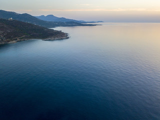 Vista aerea della costa della Corsica al tramonto, promontori che costeggiano il mare. Francia