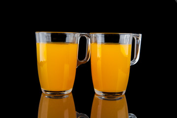 Orange juice - two glasses with oranges on black background