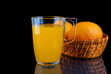 Orange juice -  glass with oranges on black background