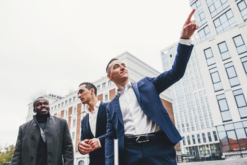 Businessman showing his colleagues the finger in the direction