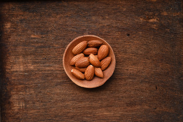 close up of almonds in wooden bowl 