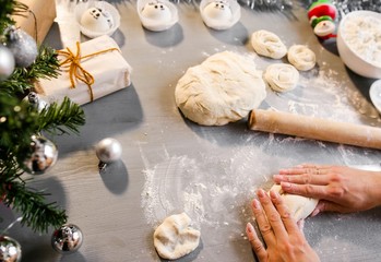 Girl in the kitchen makes the dough for baking