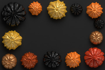 3d rendering of black, orange and gold shiny Halloween pumpkins with copyspace in the center