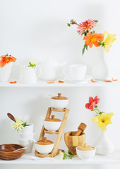 white dishvare with flowers on wooden shelf