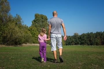 Fototapeta premium A family are running in the park at sunny day.