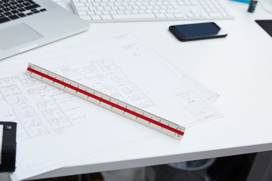High angle view of blueprints with ruler at desk in creative office