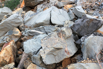 Cracks and colorful layers of sandstone background. A big heap of sandstones, storage space of various natural sandstone. The pattern of the variegated sandstones.