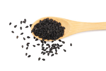 Black sesame seeds in a wooden spoon isolated on white background top view