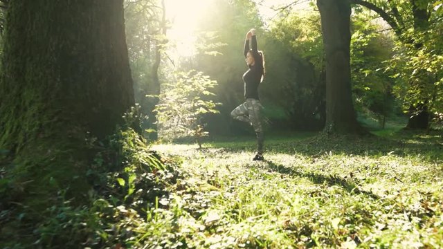 A young woman make yoga position at sunrise. .