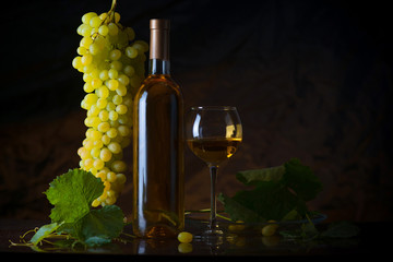 The composition of bottle glass of white wine and fresh grapes