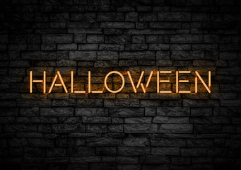 Halloween neon sign on dark wall.