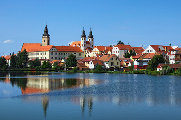 Naklejka na ściany i meble Telc is a town in southern Moravia in the Czech Republic. Telc Castle and city reflected in lake. A UNESCO World Heritage Site