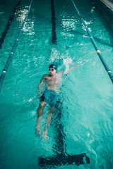 Young swimmer exercising in the pool.