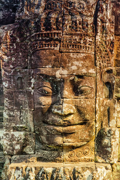 Stone murals and statue Bayon Temple Angkor Thom. Angkor Wat the largest religious monument in the world. Ancient Khmer architecture.  Location: Siem Reap, Cambodia.