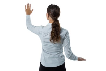 Female executive pretending to touch an invisible screen against