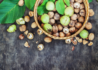 Whole Walnuts and Cleared in the basket Black Wooden Background Top view Healthy concept